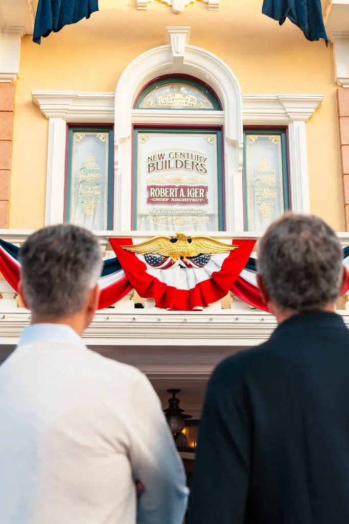Josh D'Amaro and Bob Iger look up at the new window.