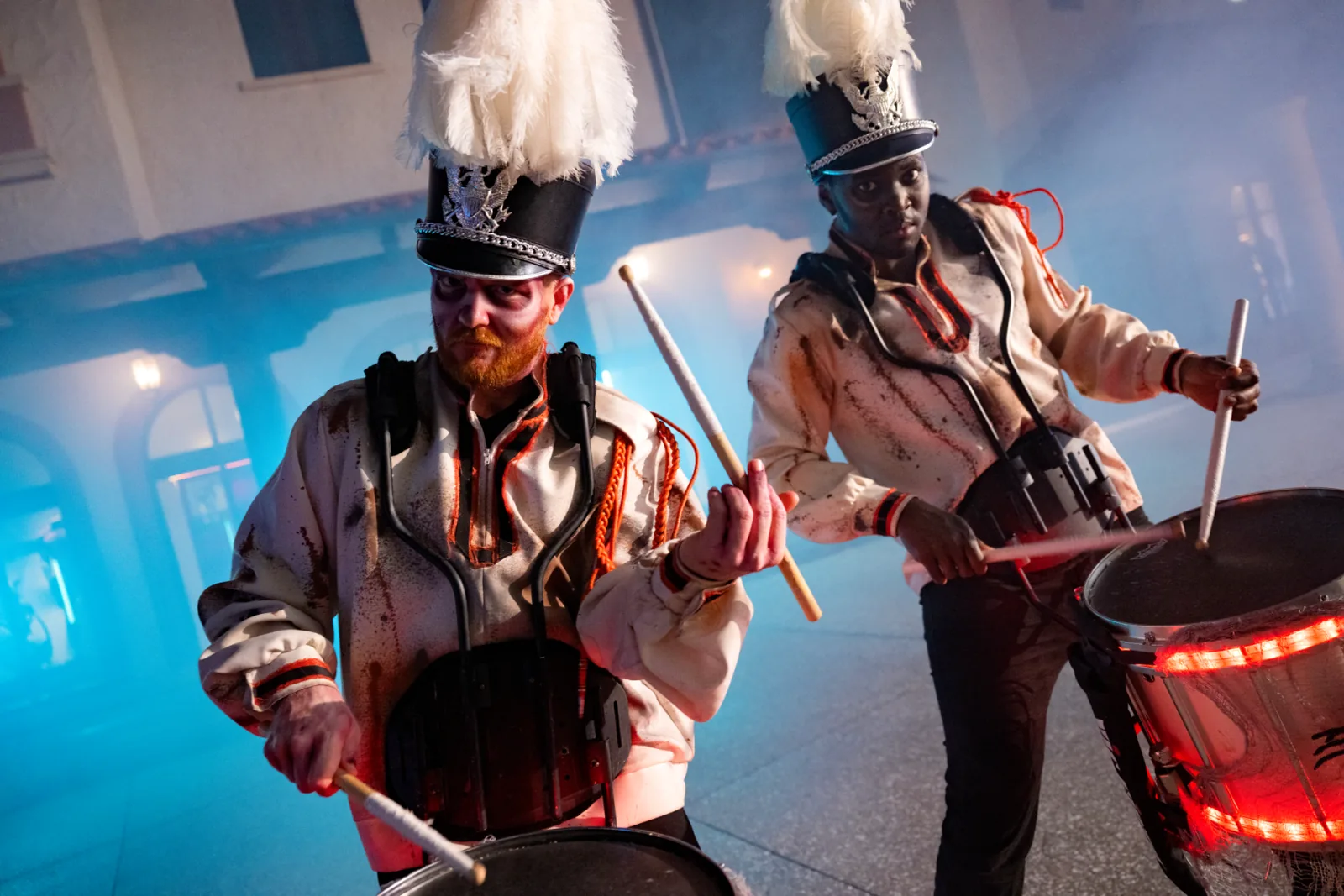Fall entertainment performers including stilt walkers and drummers