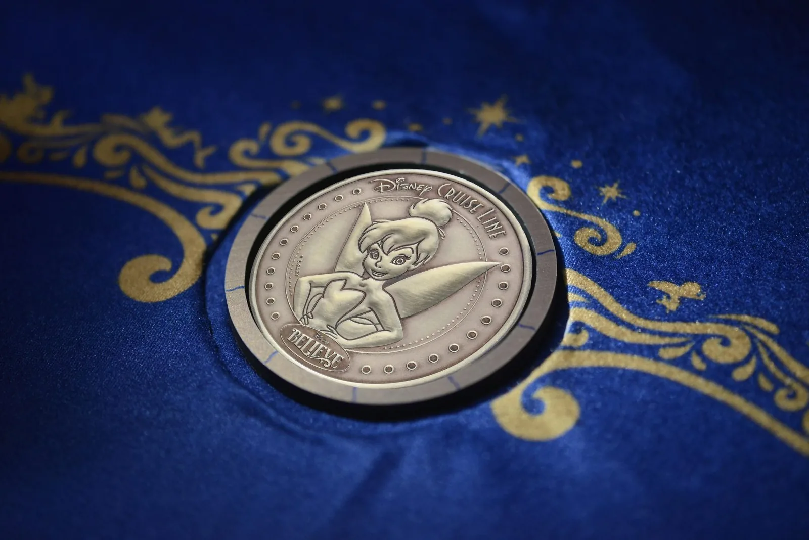 The specially minted Tinker Bell coin placed under the ship's keel