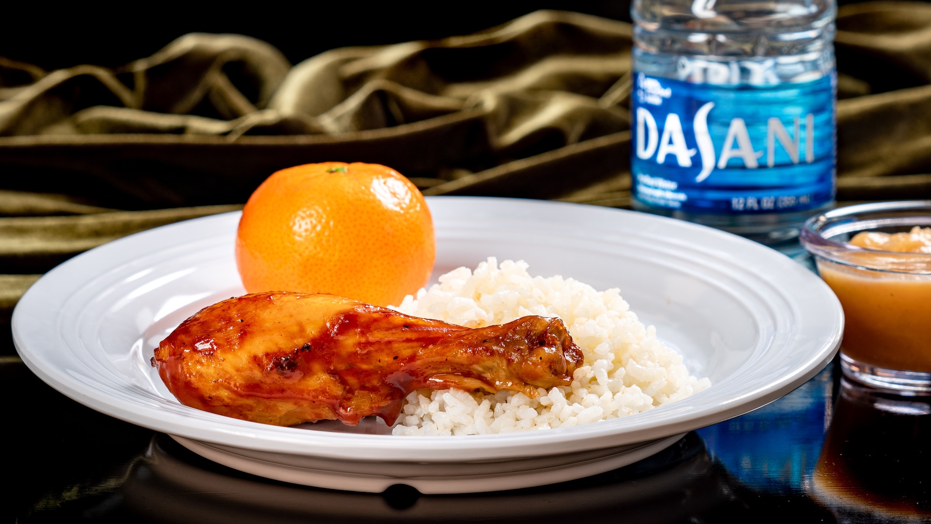 Tiana's Palace roasted chicken drumstick with sweet BBQ sauce and heirloom rice