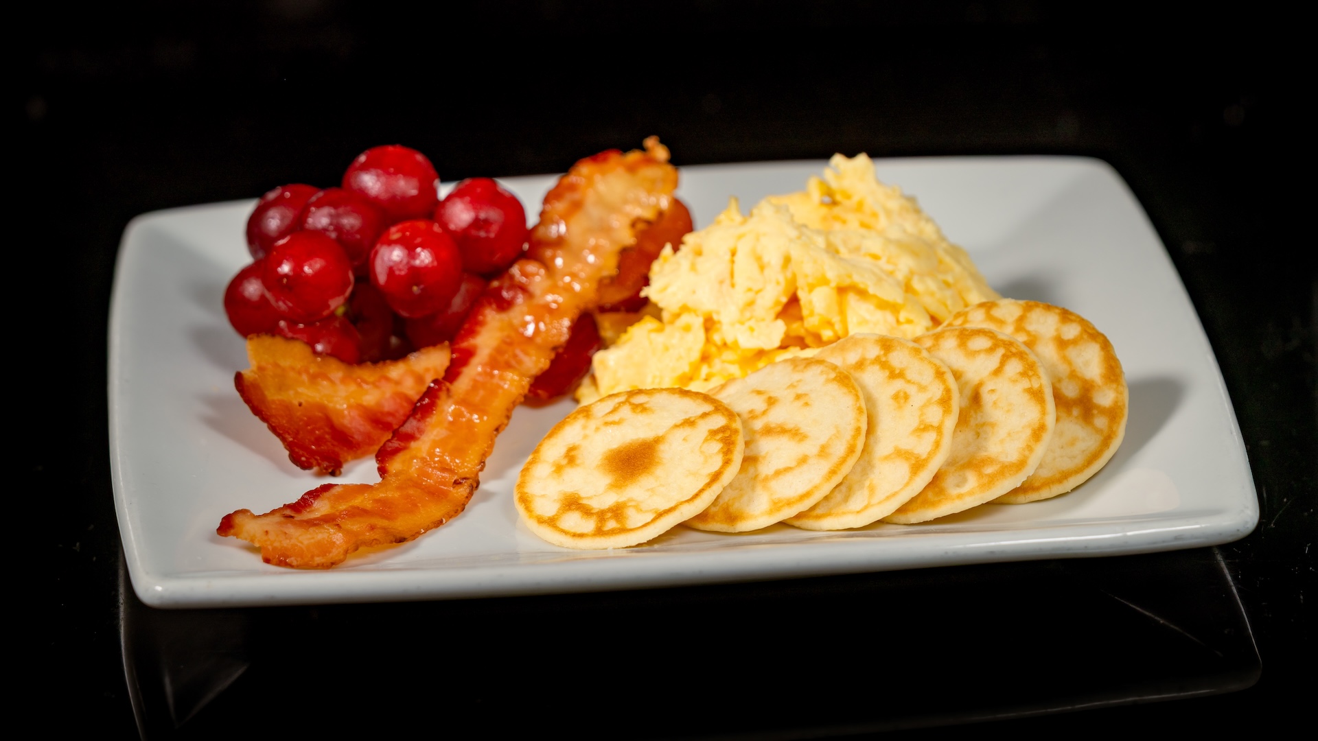 Galactic Grill mini meteor pancake kids meal with eggs, bacon, and seasonal fruit