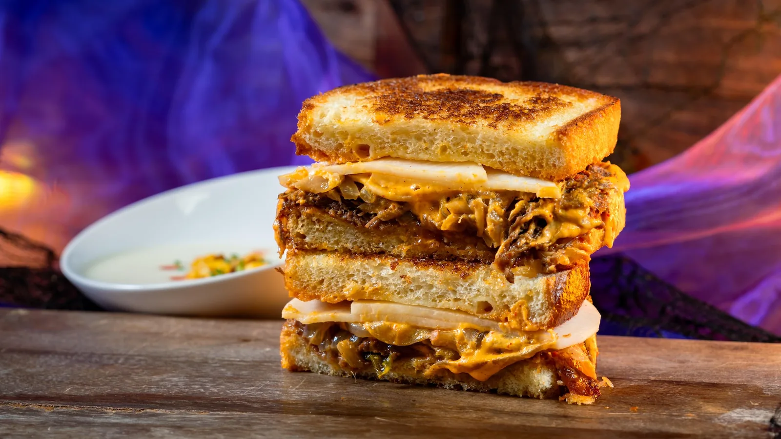 BooGogi Beef Toasted with Corn Cheese Soup: Marinated beef with grilled onion, mozzarella, pickled radish, and kimchi aïoli on sourdough