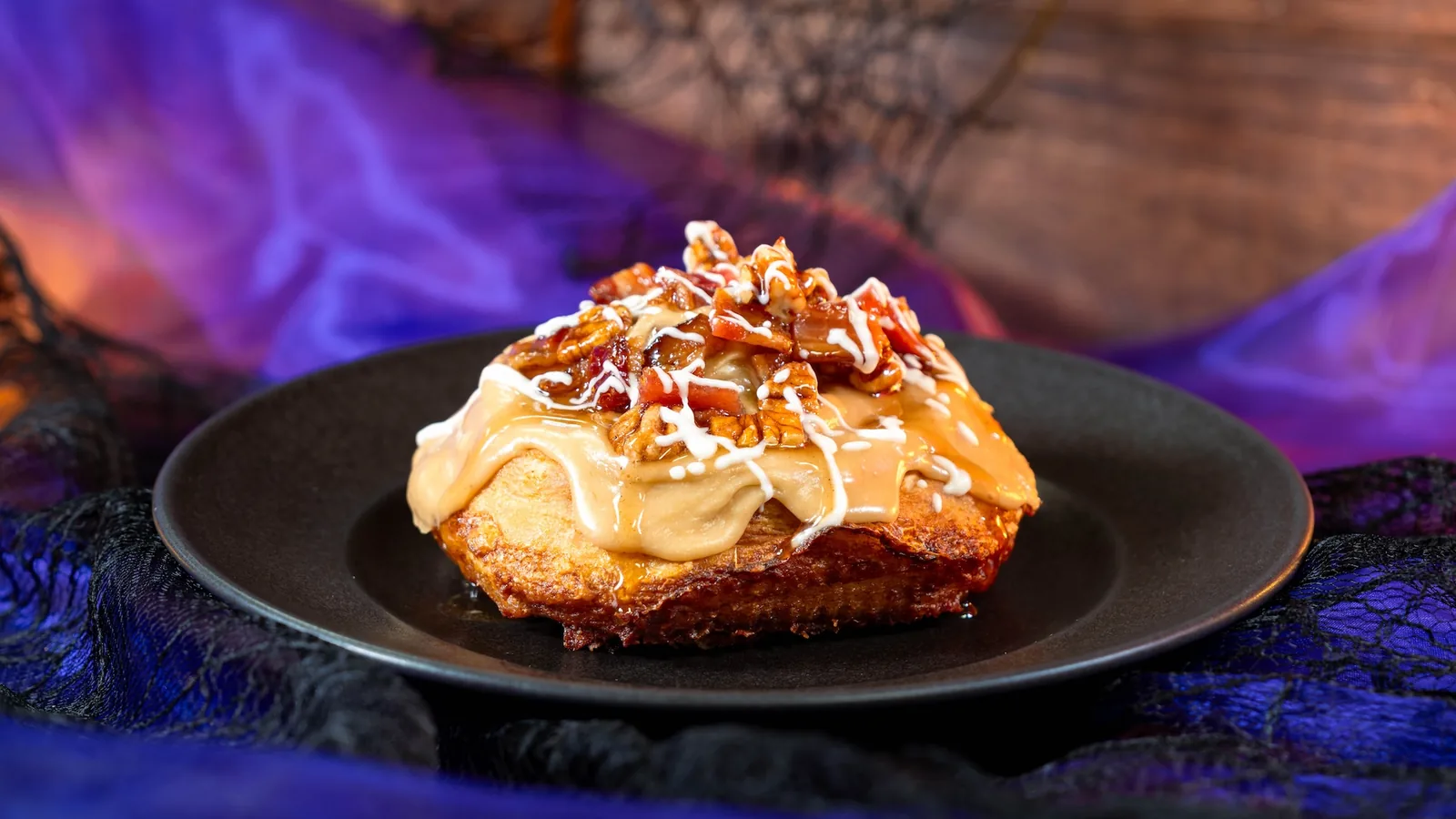 Maple-Bacon Cinnamon Roll with maple cream cheese, glazed bacon, and pecans