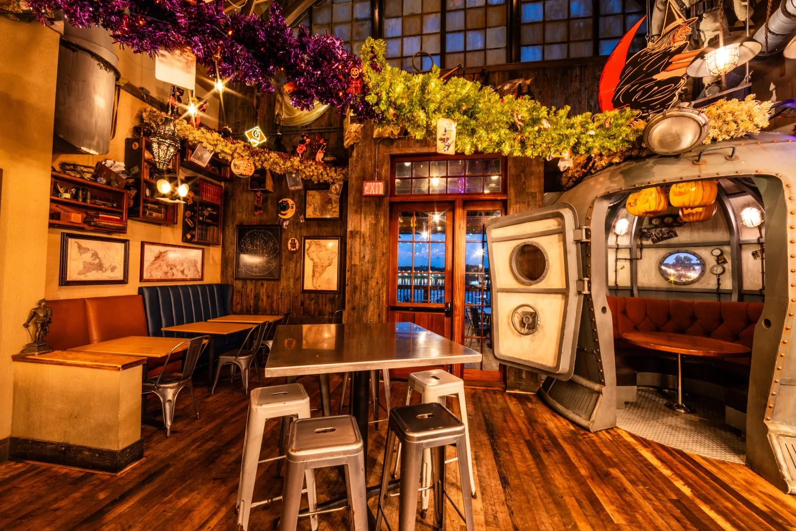 Halloween décor with witch, pumpkins, and black cats throughout the bar